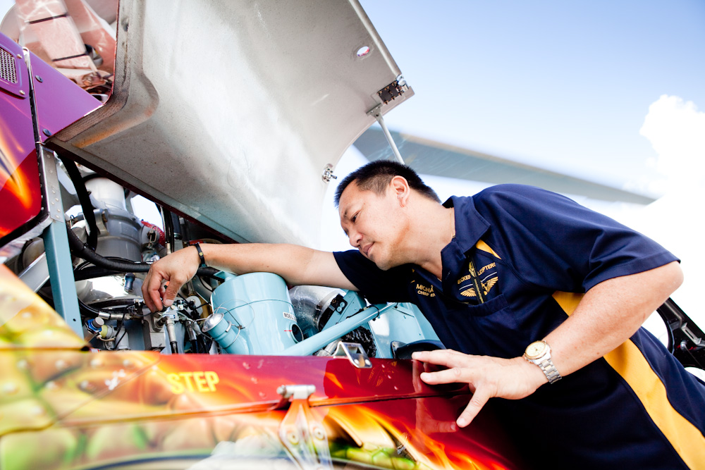 Director of Maintenance, Michael Yip, inspecting the engine bay of AS350D Squirrel Helicopter