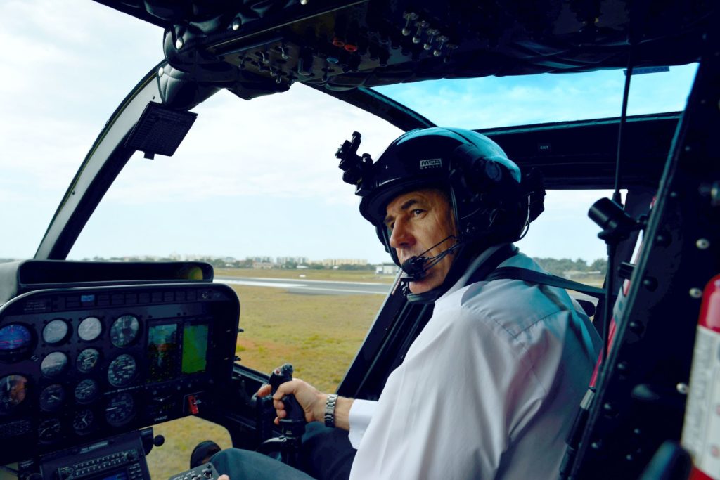 Captain Mike Becker in the cockpit of a Bell 206 Jet Ranger