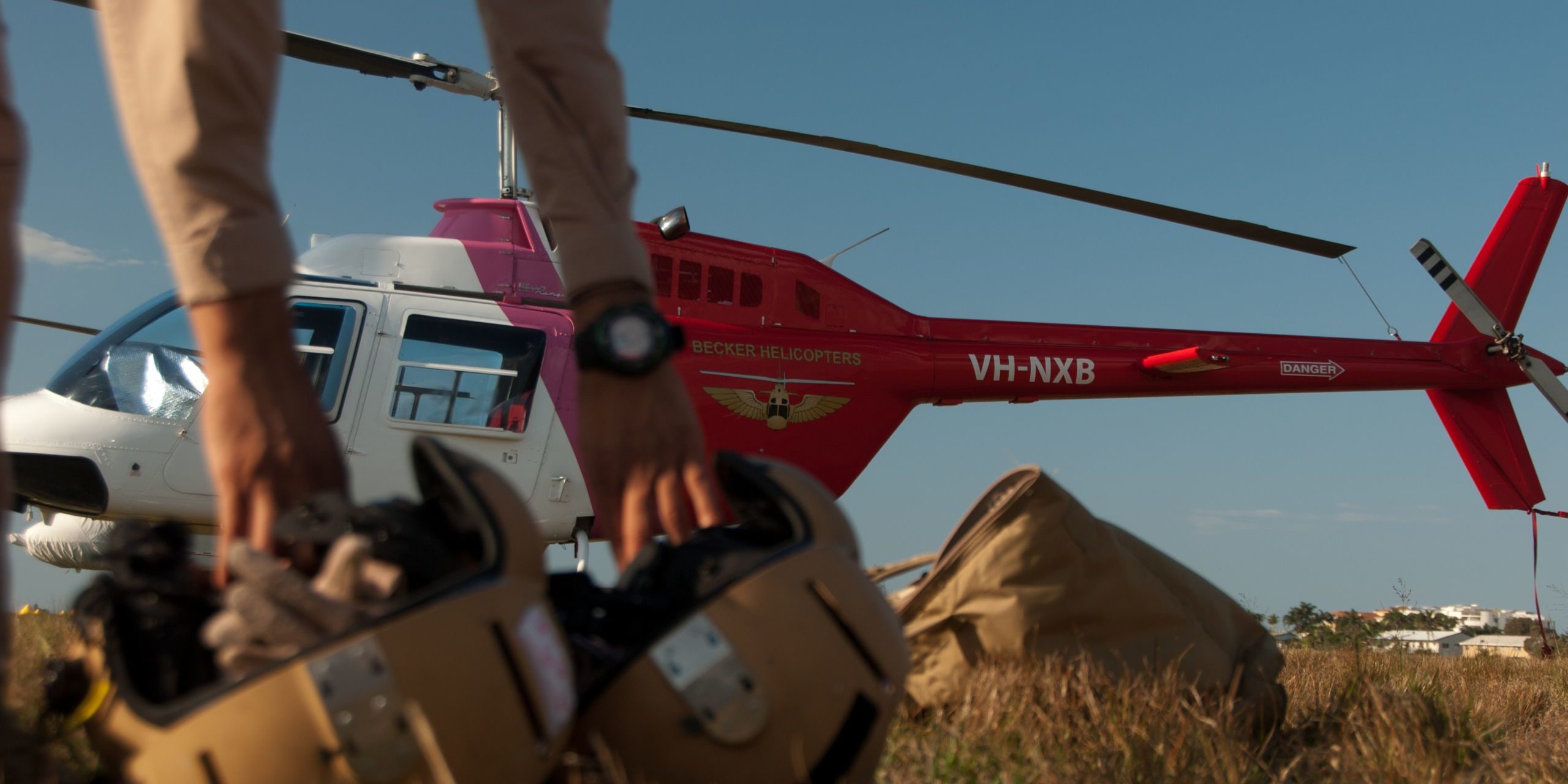 Trainee pilots picking up helmets in preparation for a training flight